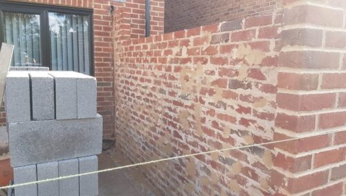 House undergoing brick wall extension